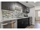 This modern kitchen features stainless steel appliances, a stylish tile backsplash, and elegant dark wood cabinets at 130 Sabal Ct # C, Oldsmar, FL 34677
