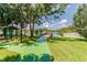 Beautiful lake view with a green path leading to a wooden dock and picnic shelter at 130 Sabal Ct # C, Oldsmar, FL 34677