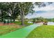Scenic lake view showcasing a picnic shelter and wooden dock with seating at 130 Sabal Ct # C, Oldsmar, FL 34677