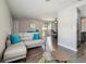 Cozy living room features stylish sectional sofa, an open floor plan with wood floors and modern furniture at 130 Sabal Ct # C, Oldsmar, FL 34677