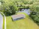 Aerial view of covered picnic pavilion with a view of the lake with water fountain feature at 130 Sabal Ct # C, Oldsmar, FL 34677
