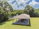 Community picnic pavilion with tables overlooks the lake and landscaped grounds for outdoor enjoyment at 130 Sabal Ct # C, Oldsmar, FL 34677