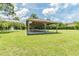Charming community picnic pavilion with tables and benches, situated in a green area with a water fountain at 130 Sabal Ct # C, Oldsmar, FL 34677