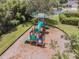 Aerial view of the community playground with a tubular slide, green slide, and climbing structure at 130 Sabal Ct # C, Oldsmar, FL 34677