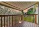 Relaxing porch view overlooking a grassy yard with mature trees and distant home at 130 Sabal Ct # C, Oldsmar, FL 34677