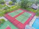 Aerial view of the community tennis and basketball courts in the pool area at 130 Sabal Ct # C, Oldsmar, FL 34677