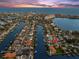 Aerial view showing the home's proximity to the water and community with a beautiful sunset backdrop at 139 Wall St, Redington Shores, FL 33708