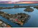 An aerial view shows the home's waterfront location, the community, boat dock, and the Gulf beyond at 139 Wall St, Redington Shores, FL 33708