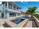 Backyard with a swimming pool, jacuzzi, seating area, and lush landscaping at 139 Wall St, Redington Shores, FL 33708