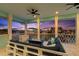Balcony featuring a fire pit, comfortable seating, and views of a colorful sunset at 139 Wall St, Redington Shores, FL 33708