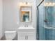 Bathroom with vanity, shower, and modern fixtures with a blue-tiled shower at 139 Wall St, Redington Shores, FL 33708