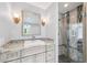 Bathroom showcasing marble countertop vanity and glass-enclosed shower with gray and beige tile at 139 Wall St, Redington Shores, FL 33708