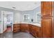 Bathroom featuring dual sinks, wooden cabinets, and tile flooring at 139 Wall St, Redington Shores, FL 33708