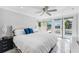 Bedroom featuring ceiling fan, marble floors, and glass block windows at 139 Wall St, Redington Shores, FL 33708