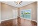 Bright bedroom featuring beautiful wood floors, sliding glass doors, and a balcony overlooking the water at 139 Wall St, Redington Shores, FL 33708