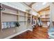 Spacious walk-in closet with custom shelving and hardwood floors at 139 Wall St, Redington Shores, FL 33708