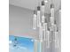 A modern chandelier with chrome accents hangs in dining room at 139 Wall St, Redington Shores, FL 33708