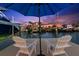 Enjoy a sunset water view from the dock with comfortable chairs in front of the home at 139 Wall St, Redington Shores, FL 33708