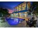 The stylish home showcases a beautiful pool, with a spiral staircase and balconies at 139 Wall St, Redington Shores, FL 33708