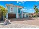 Charming two-story waterfront home with a brick driveway, ample parking, and a two-car garage at 139 Wall St, Redington Shores, FL 33708