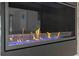 Modern fireplace with blue decorative stones, set into a textured tile wall at 139 Wall St, Redington Shores, FL 33708