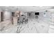 Spacious open kitchen features an island with seating, marble floors, and stainless steel appliances at 139 Wall St, Redington Shores, FL 33708