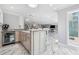 Open concept kitchen with stainless appliances and view of living area at 139 Wall St, Redington Shores, FL 33708