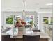 Granite kitchen island with sink and breakfast bar seating overlooking waterfront view at 139 Wall St, Redington Shores, FL 33708