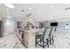 Bright kitchen with marble floors, an island with seating, and modern appliances at 139 Wall St, Redington Shores, FL 33708