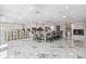 Open-concept living area with fireplace, large kitchen island, and marble floors at 139 Wall St, Redington Shores, FL 33708