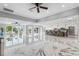 Bright, open living space with a large island, marble floors, and waterfront views through expansive windows at 139 Wall St, Redington Shores, FL 33708