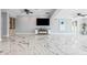 Spacious living room with marble floors, a TV, and built-in shelving at 139 Wall St, Redington Shores, FL 33708