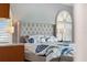 Tastefully decorated bedroom featuring a plush bed, designer lamps and shuttered windows at 139 Wall St, Redington Shores, FL 33708