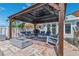 Outdoor lounge area features a covered patio, comfortable seating, and a modern fire pit at 139 Wall St, Redington Shores, FL 33708