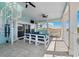 Spacious patio with outdoor seating, tile floors, spiral staircase, and water views at 139 Wall St, Redington Shores, FL 33708