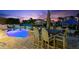 Outdoor dining with views of the illuminated pool and waterfront at 139 Wall St, Redington Shores, FL 33708