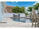 Outdoor pool with lounge chairs and a white fence at 139 Wall St, Redington Shores, FL 33708