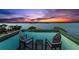 Enjoy breathtaking sunset views from the home's roof deck with comfortable seating and serene ambiance at 139 Wall St, Redington Shores, FL 33708