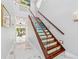 Elegant staircase with wood steps, decorative risers, glass railing and ample natural light at 139 Wall St, Redington Shores, FL 33708