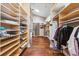 Large walk-in closet with custom wood shelving and skylight providing ample storage space at 139 Wall St, Redington Shores, FL 33708