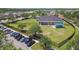 Aerial view showcasing a community building with a large lawn, play area, and parking at 14705 Canopy Dr, Tampa, FL 33626