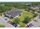 Aerial view showcases community building, expansive lawn, playground and ample parking at 14705 Canopy Dr, Tampa, FL 33626