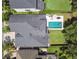 An aerial view of a beautiful home, showing the large roof, backyard pool, and surrounding landscaping at 14705 Canopy Dr, Tampa, FL 33626