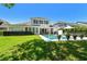 Beautiful backyard with a pristine pool, lush green grass, and outdoor seating area perfect for relaxation at 14705 Canopy Dr, Tampa, FL 33626