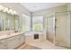 Bright bathroom featuring a soaking tub, separate shower, and plenty of natural light at 14705 Canopy Dr, Tampa, FL 33626