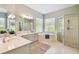 Bright bathroom featuring a soaking tub, separate shower, and dual sinks with lots of natural light at 14705 Canopy Dr, Tampa, FL 33626