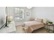 Bright bedroom with a chair swing, neutral color tones, and hardwood flooring at 14705 Canopy Dr, Tampa, FL 33626