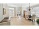 Open concept room with wood flooring and a dining set situated by a window at 14705 Canopy Dr, Tampa, FL 33626