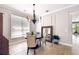 Elegant dining room with modern chandelier, decorative mirror, and plenty of natural light at 14705 Canopy Dr, Tampa, FL 33626