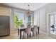 Formal dining room with a chandelier, large window, and elegant decor near kitchen at 14705 Canopy Dr, Tampa, FL 33626